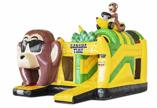 Opblaasbaar springkasteel met obstakels erin en een glijbaan in bananen apen thema te koop