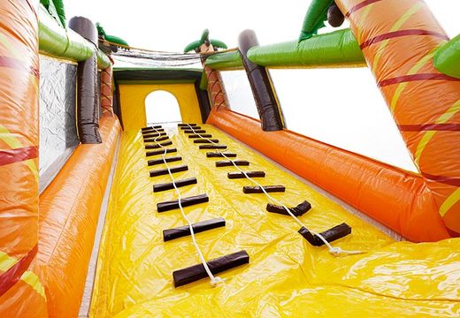 Climbing on a large obstacle course bouncy castle
